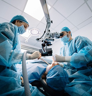 Dentists conducting a dental implant surgery