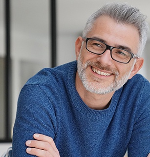 man smiling after getting dentures 